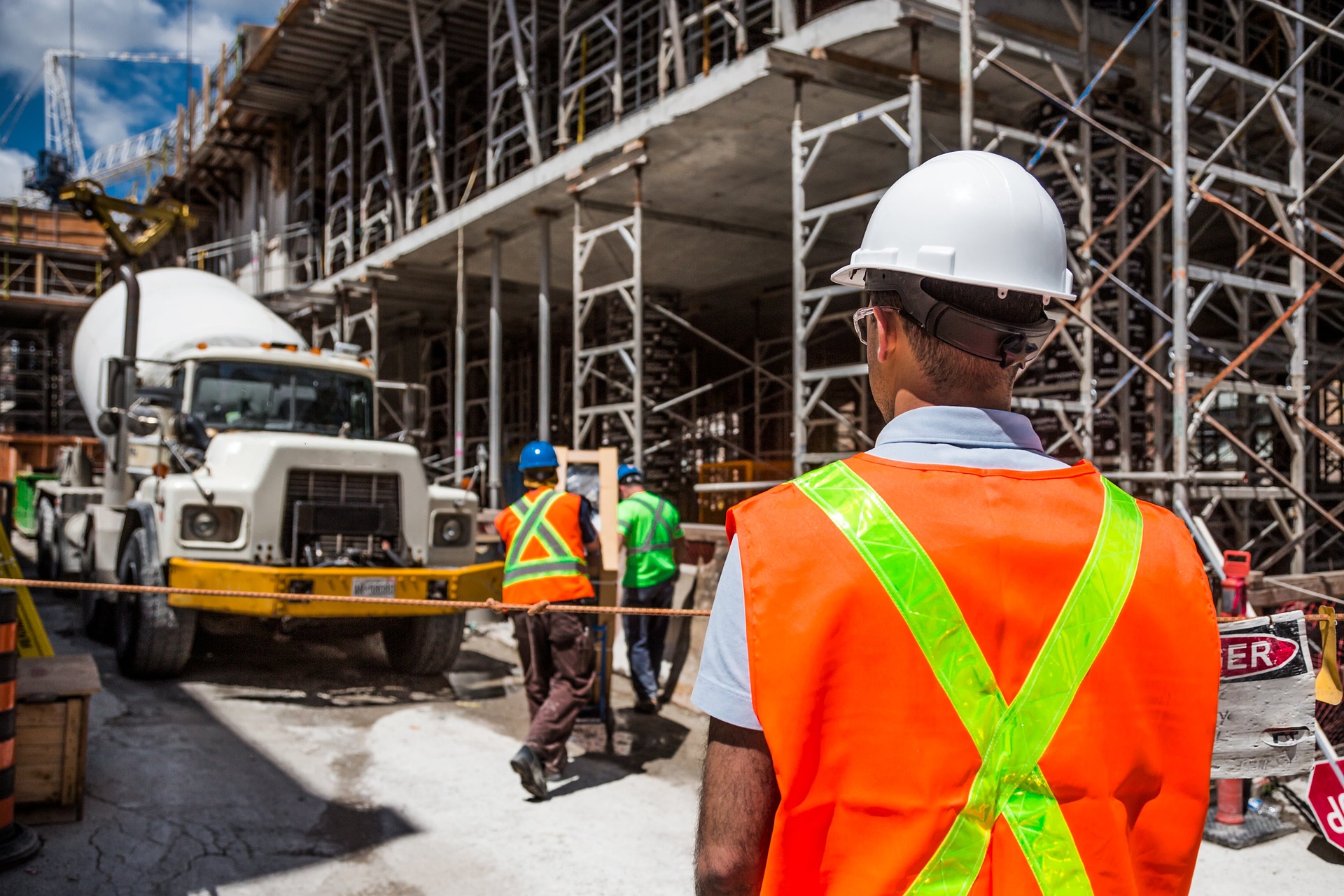 photo of construction workers putting up scaffolding