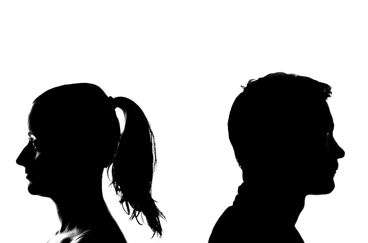 silhouette of man and woman back to back