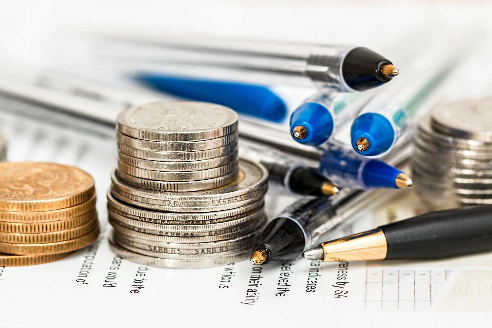 stacks of coins and pens