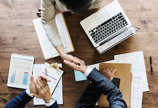 Business people shaking hands together